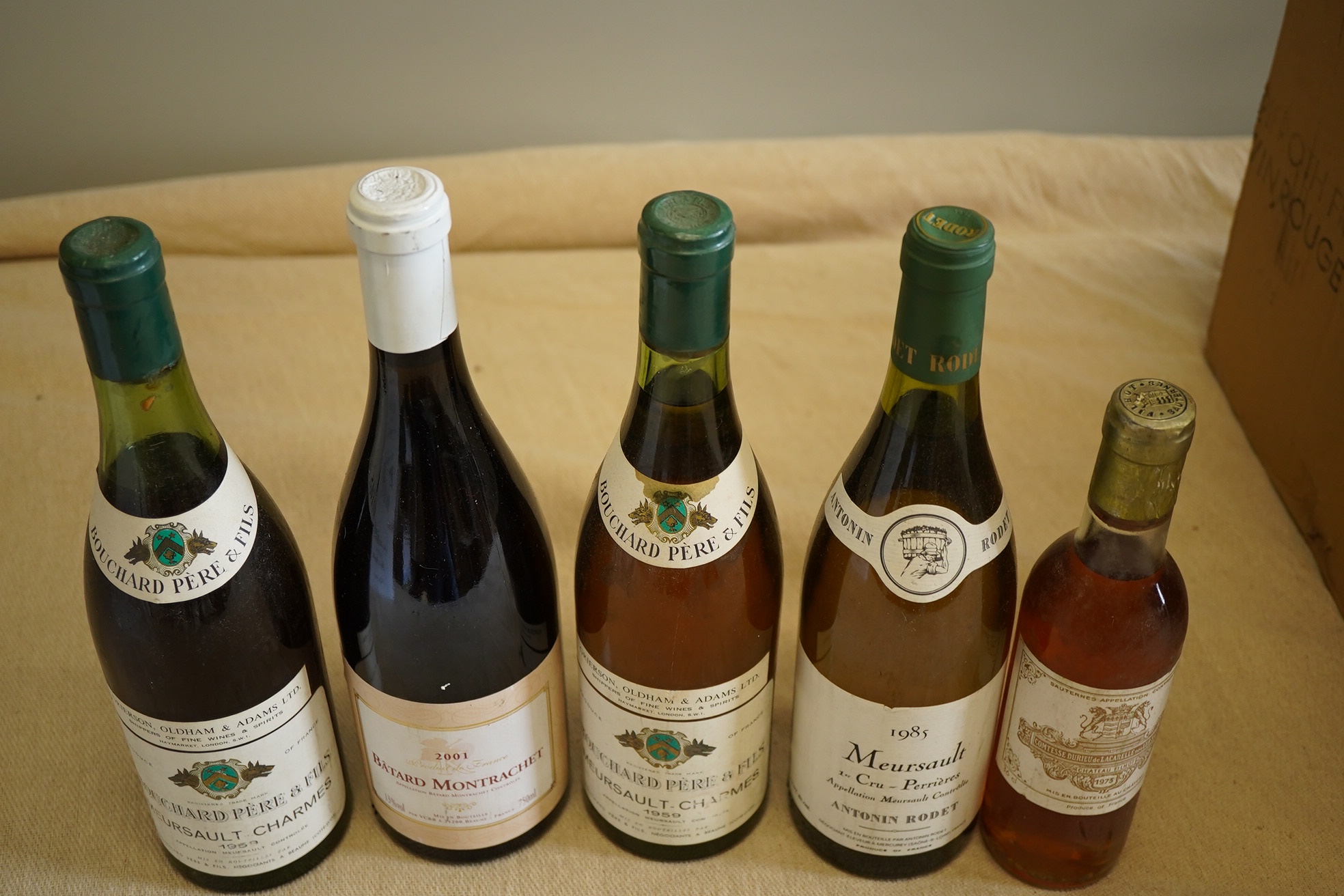 One bottle of 1985 Meursault 1er Cru, Antonin Rodet, one bottle of 2001 Batard Montrachet, two bottles of 1959 Meursault Charmes, Bouchard Pere & Fils and one half bottle of 1973 Chateau Filot, Sauternes. (5)
